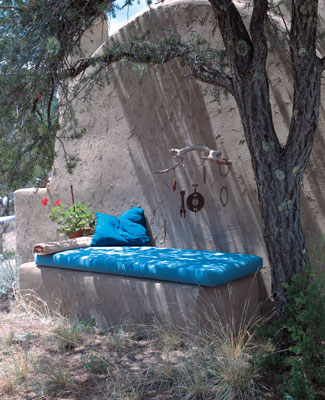 
This day bench receives a mix of light and shade and the kinetic energy of this mobile, created by Dyanna from objects she has found during her travels and on her property.
